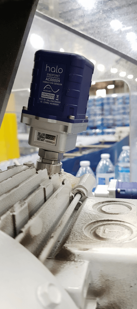 A blue bottle machine in a factory.