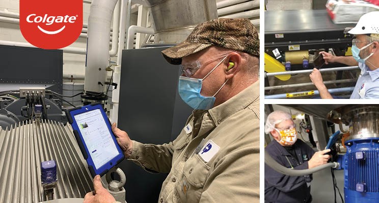 Men in factory checking machines with laptops