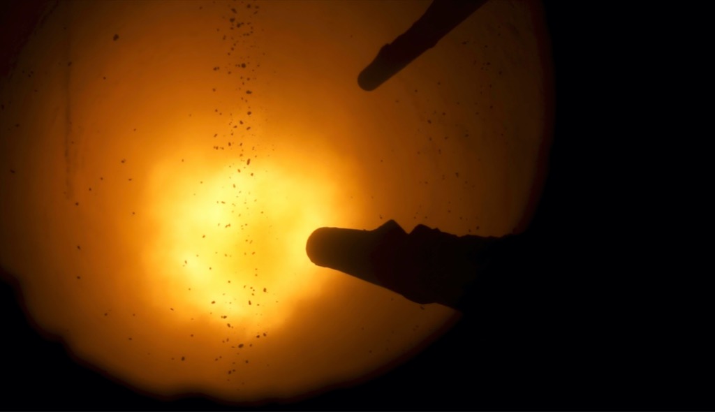 Top view of hot red iquid metal inside blast furnace.