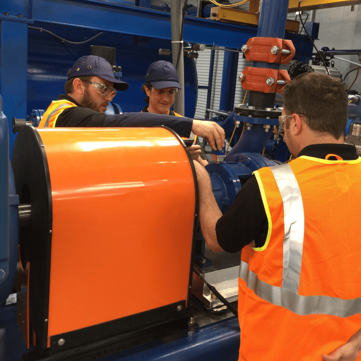 A group of men working on a production machine.