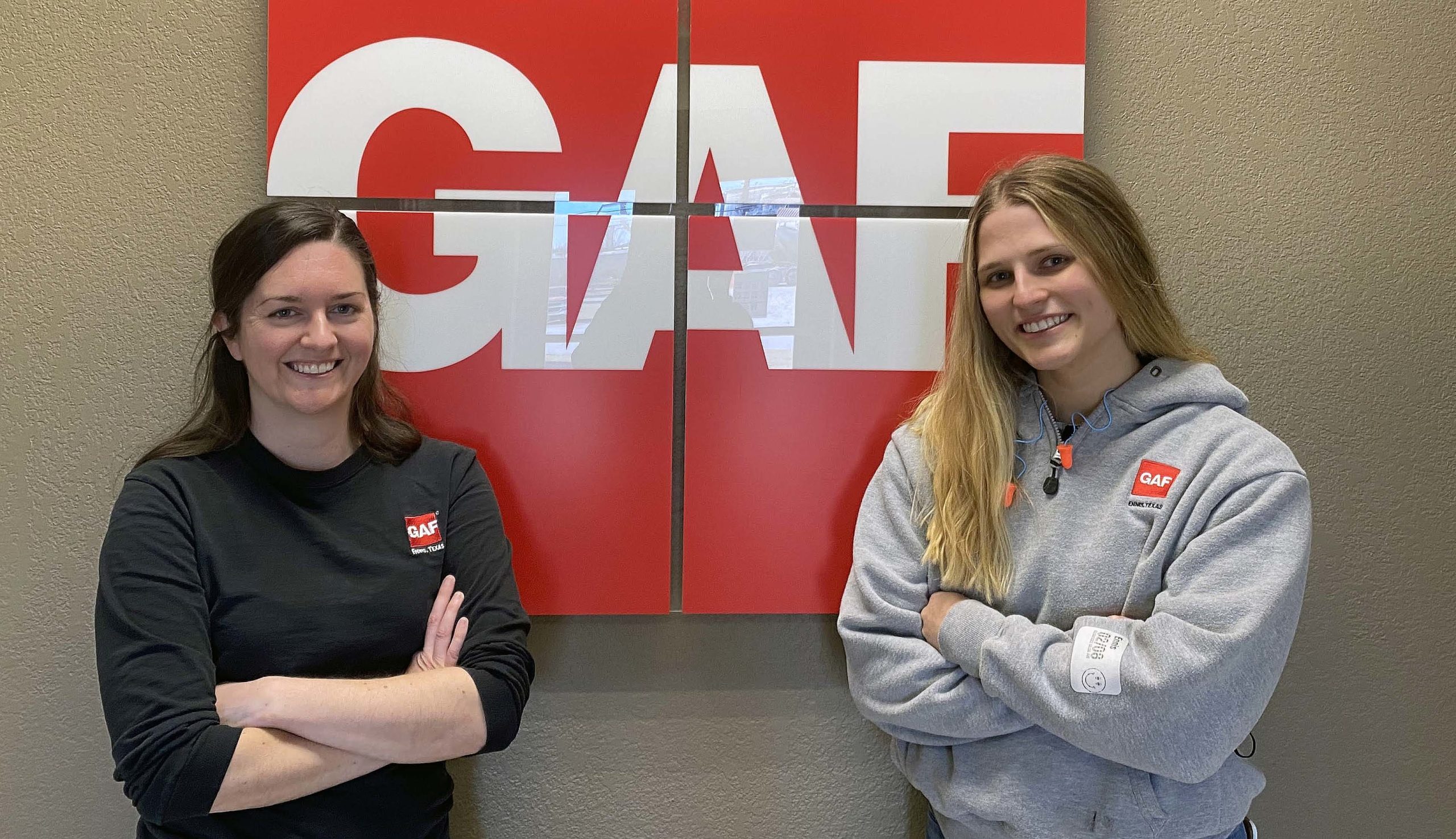 Picture of Amanda and Shelby in front of GAF logo.