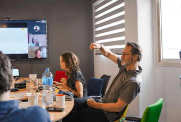 A group of people sitting about a table in a conference room.