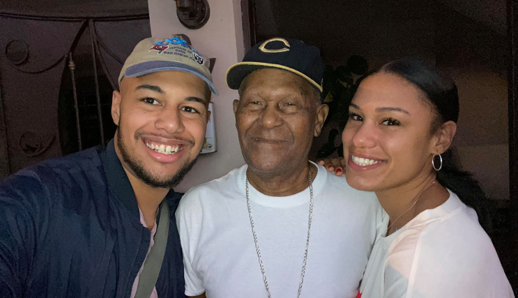 A couple posing for a selfie with an elderly man emphasizing the importance of connection in today's world.