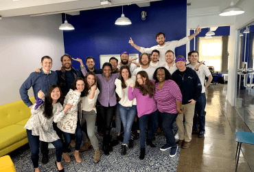 A group of people posing for a photo in an office.