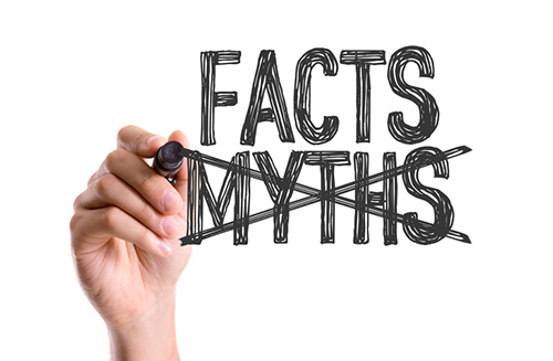Hand with marker writing the word Facts Myths. As in: the facts on predictive maintenance