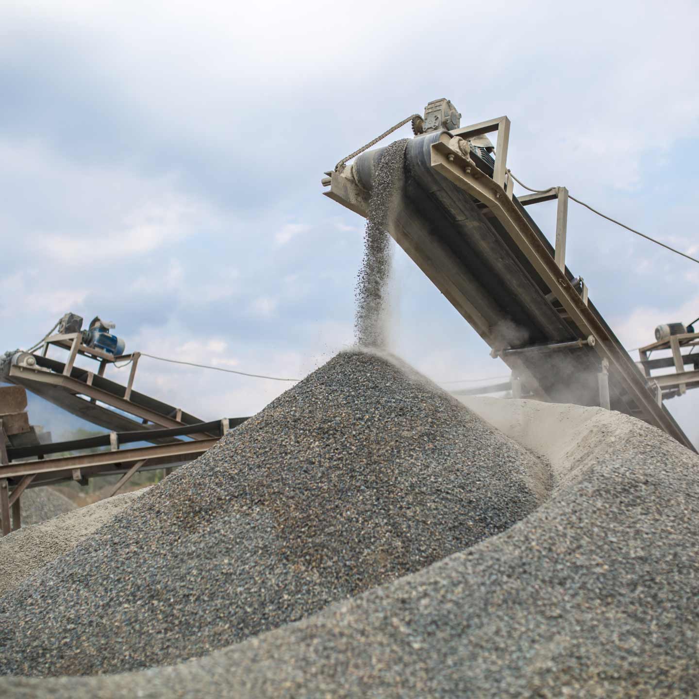 A conveyor belt is being used to sift building materials.