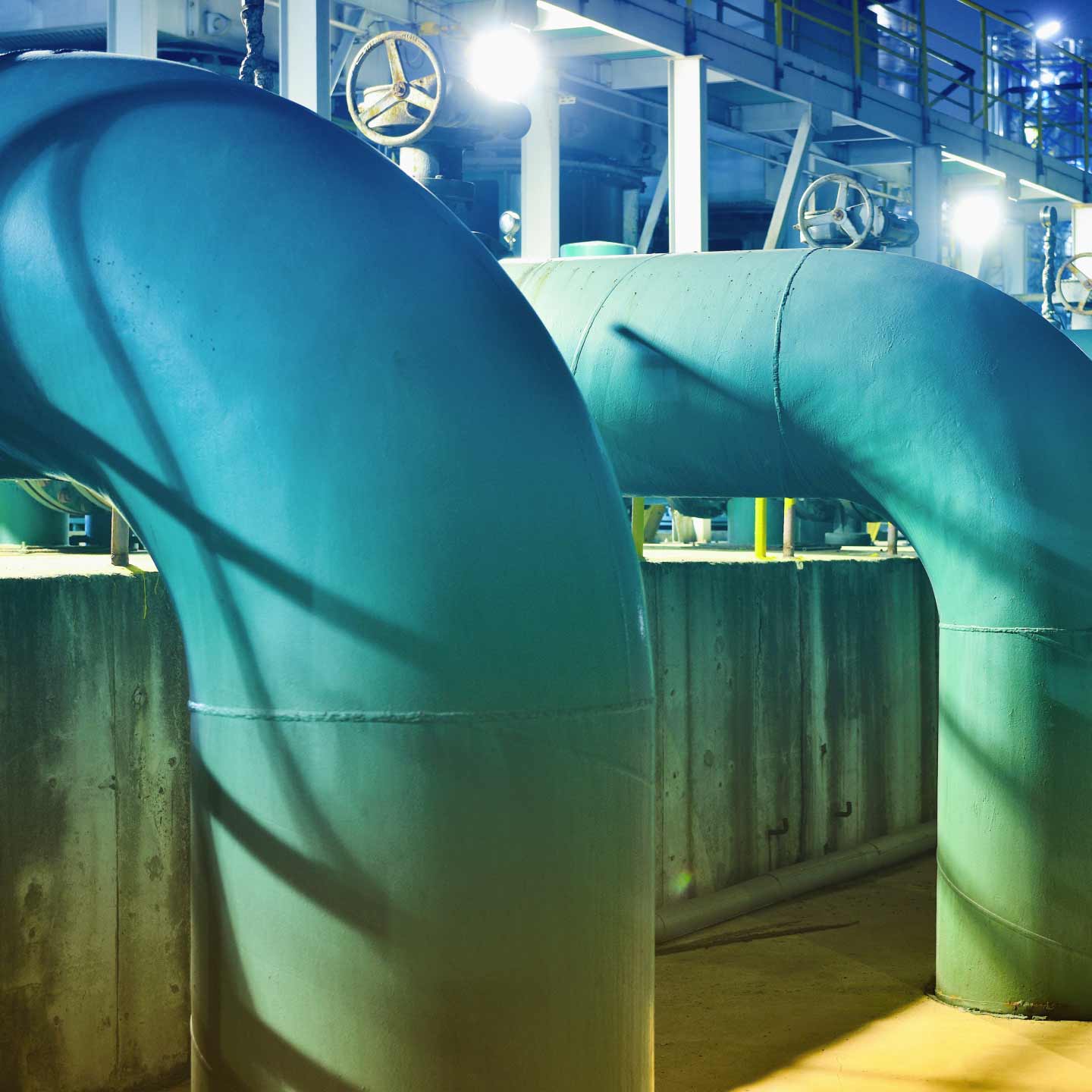 A group of pipes carrying chemicals in a factory.