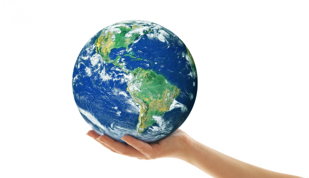 Individual hand holding Earth