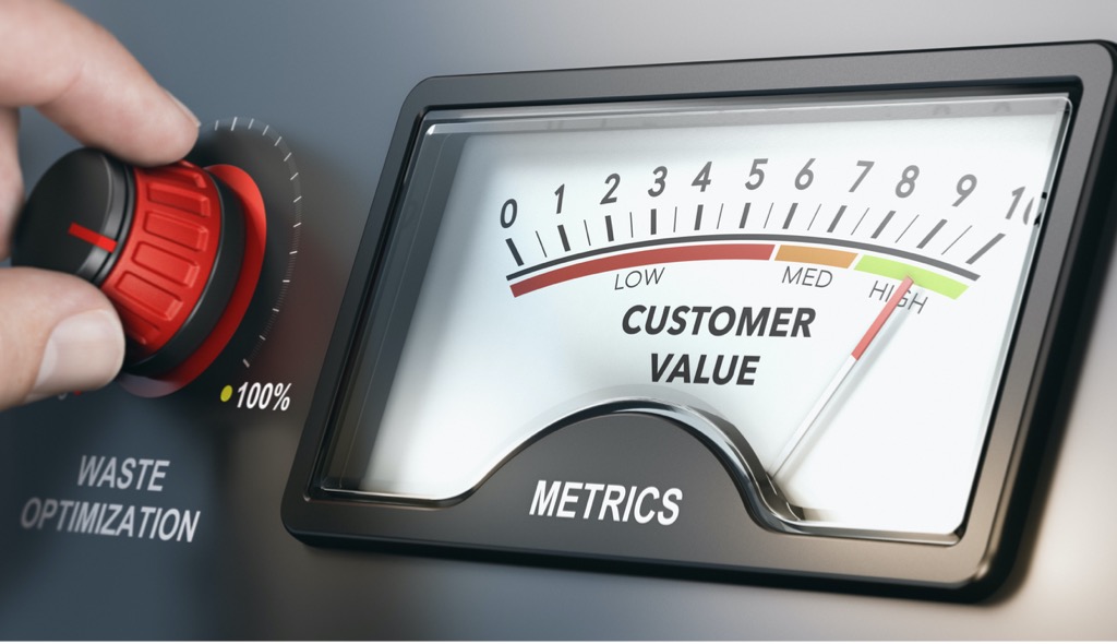 Finger turning a Waste Optimization knob while meter shows increase in Customer Value.