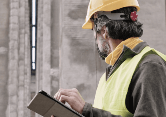 A construction worker using Microsoft Azure to manage a construction site.