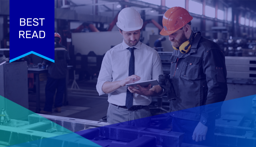 Two men in hard hats looking at a tablet with Augury.