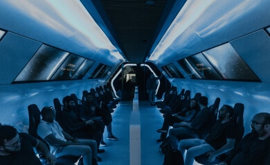 A group of people sitting on a train with blue lights, showcasing diverse careers.
