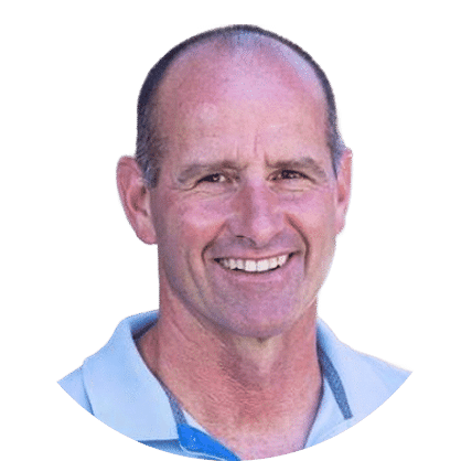 Smiling middle-aged man with short hair, wearing a light blue collared shirt, photographed against a plain white background.