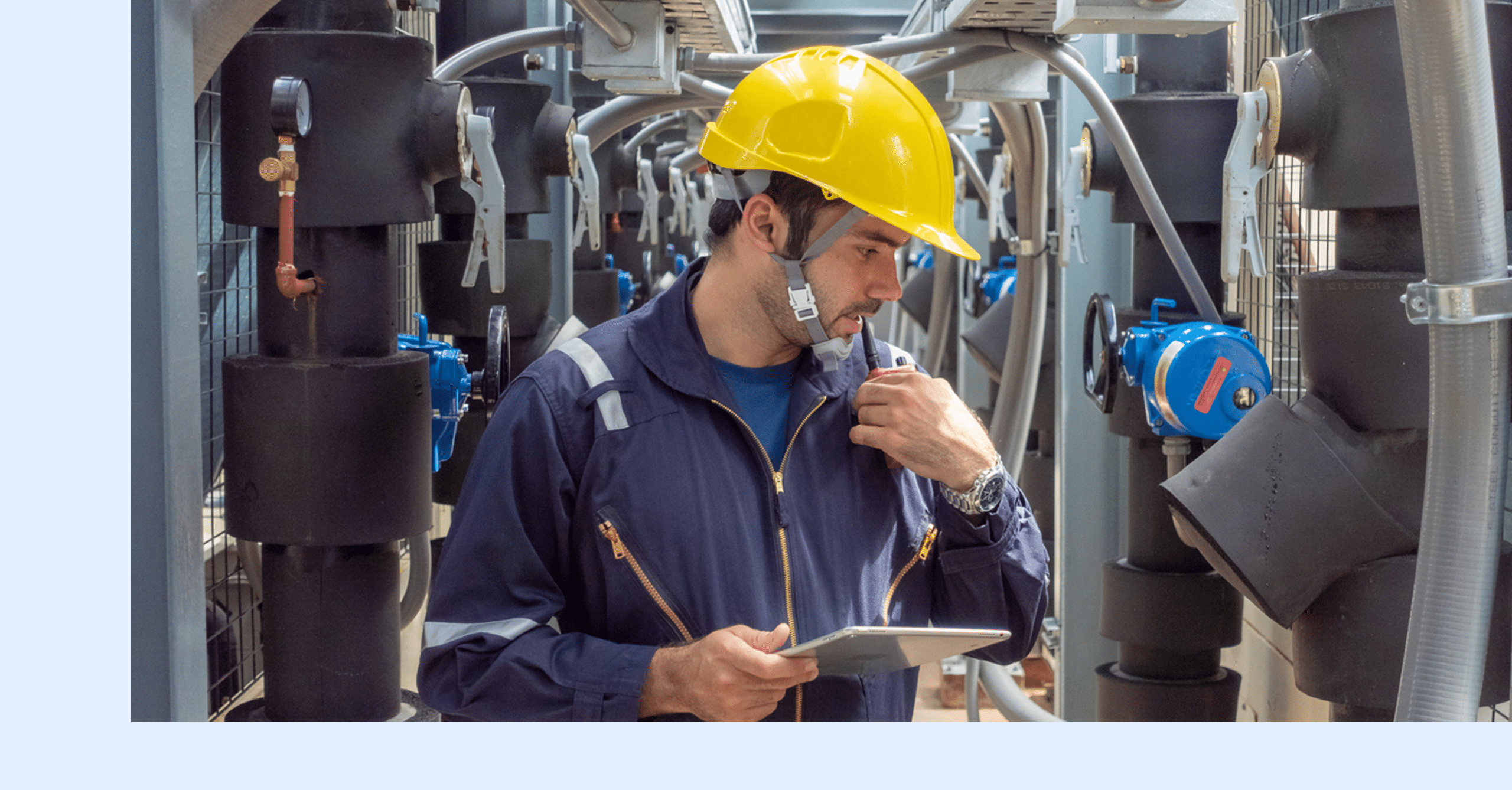 A worker performing maintenance checks on manufacturing equipment.