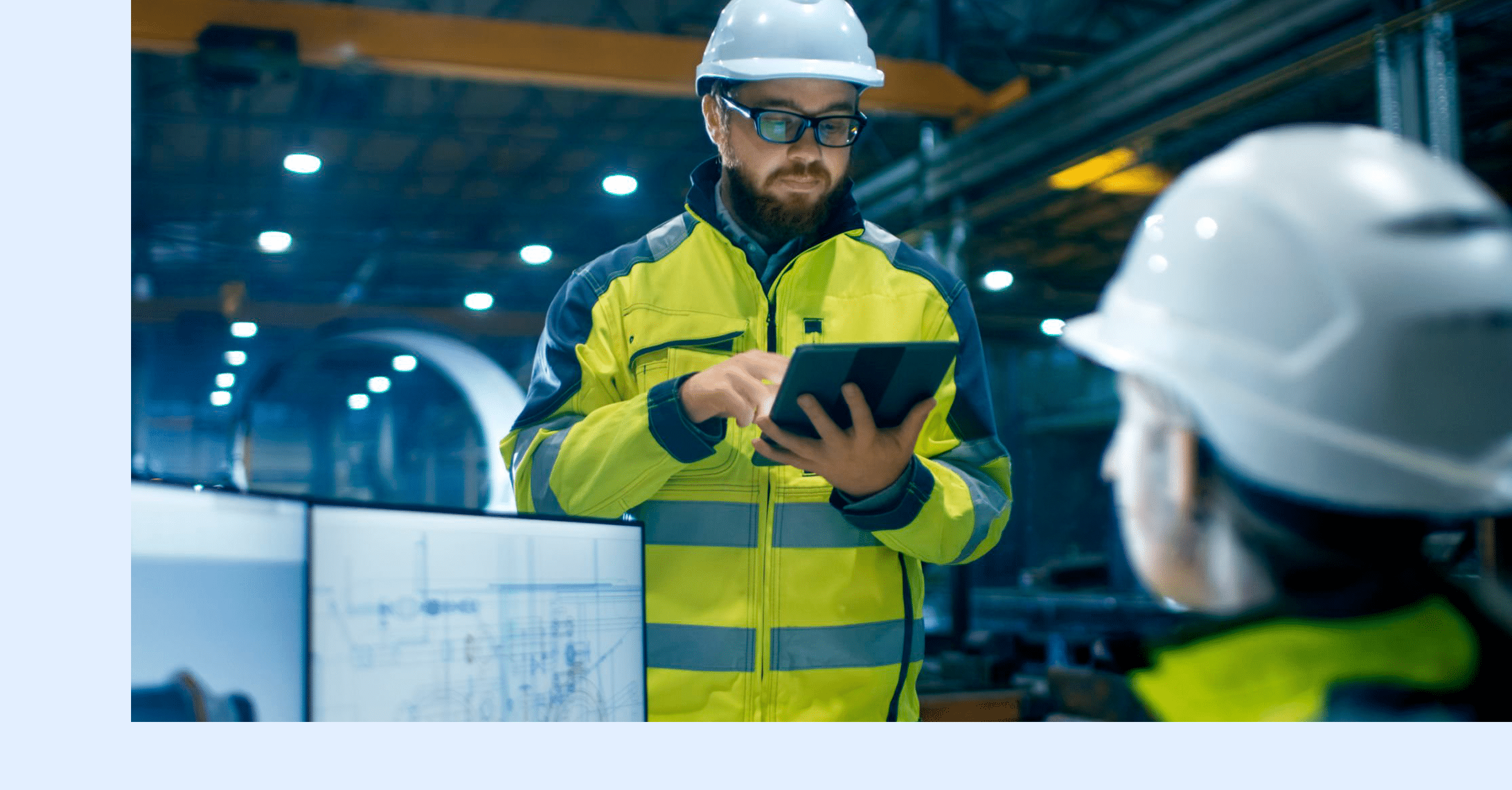 A plant engineer reviews industrial maintenance KPIs on a digital tablet.