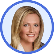 Portrait photo of a woman with blonde hair, smiling, wearing a white top and a dark jacket, shown inside a blue circular border on a light background.