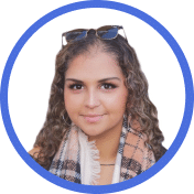 Portrait of a woman with curly hair, wearing sunglasses on her head and a checked scarf, inside a blue circular frame on a white background.