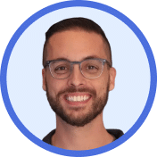 A man with glasses smiling.