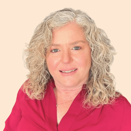 A woman with gray hair in a red shirt named Sigal.