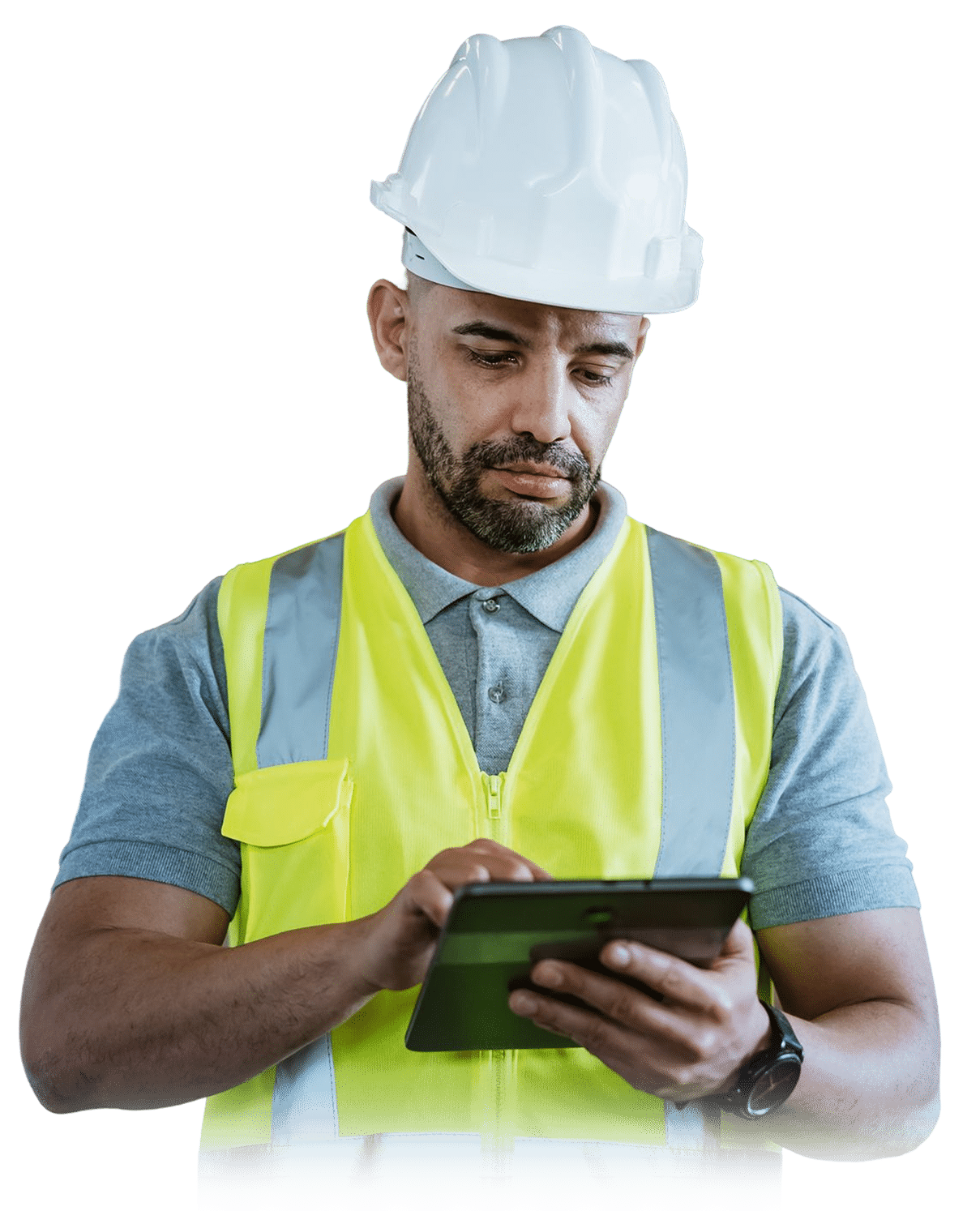 A man wearing a white hard hat and yellow safety vest uses a tablet, focusing on the screen.