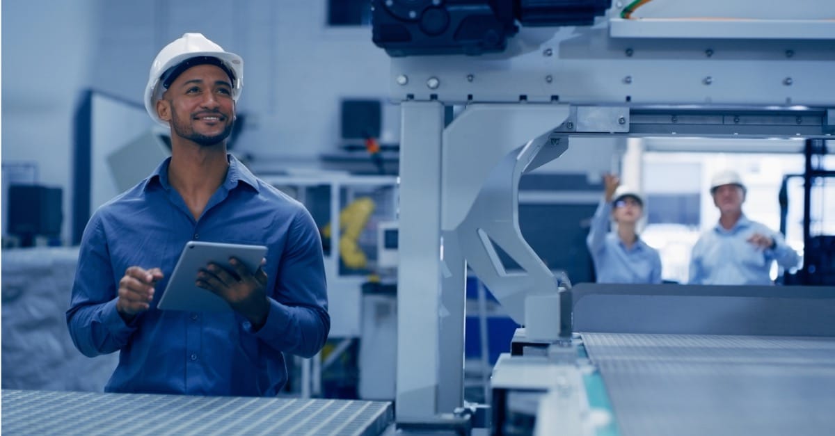 Engineer in robotics factory using an AI copilot on his tablet