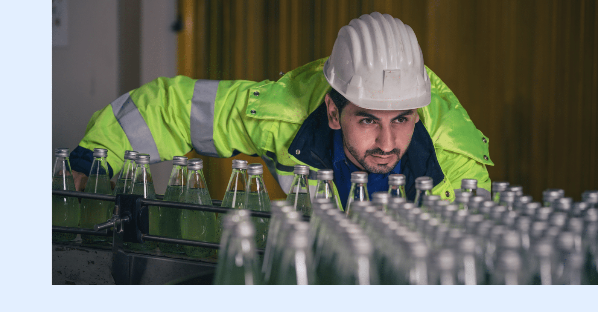A manufacturing plant worker overseeing the progress of an active production line.
