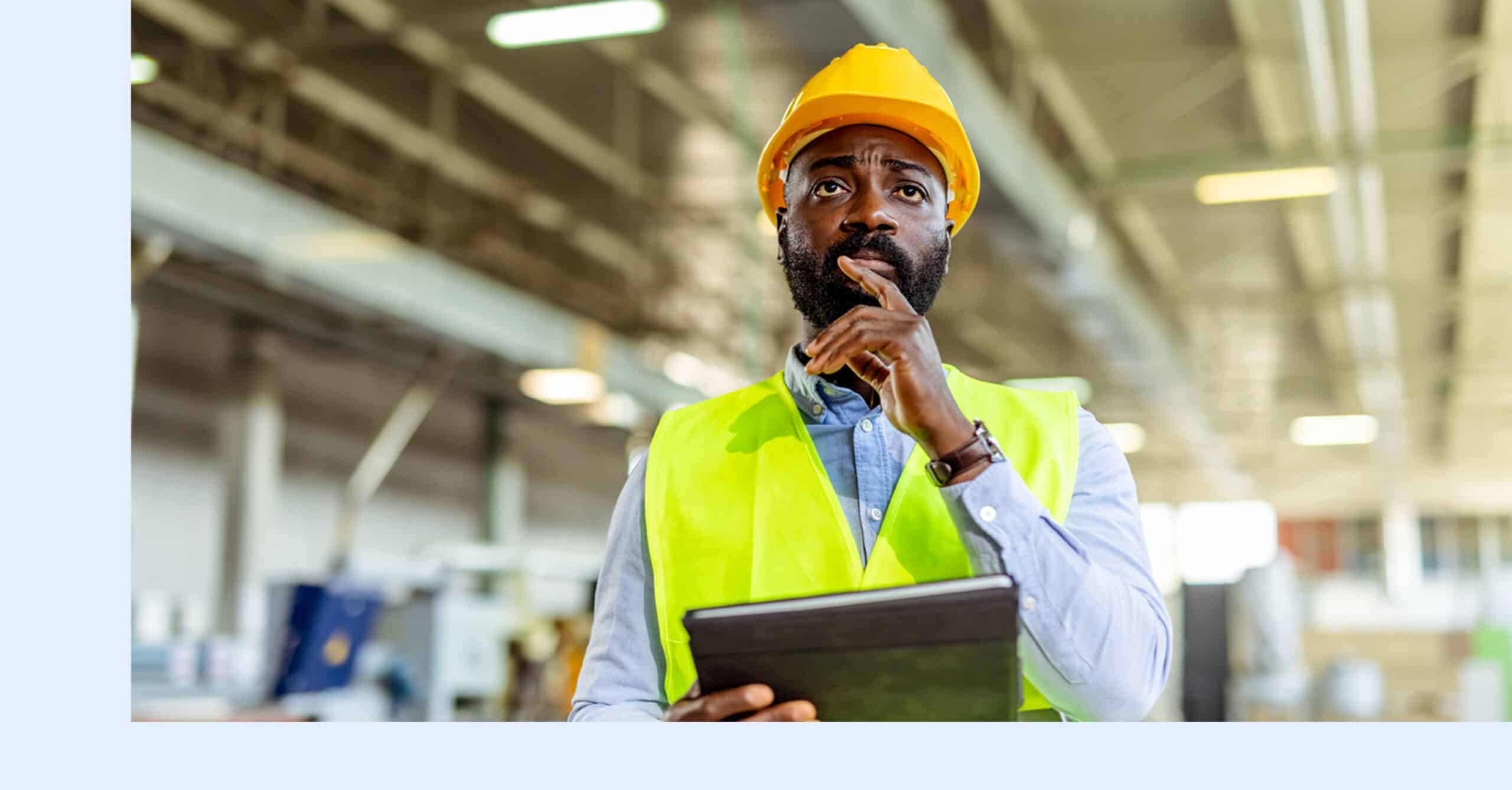A reliability expert using predictive maintenance analytics to inspect critical assets on the plant floor.